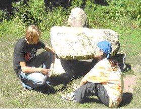  Matt and Sean sitting at the Stone Circle's three ton central trilithion altar surrounded by a dozen man-sized boulders, a quiet and gentle place to relax.